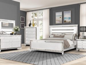 A bedroom with a bed, dresser and mirror.