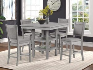 A dining room table with four chairs and a clock.