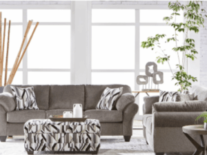 Grey sofa set with patterned pillows.