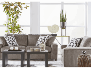 Gray sectional sofa with patterned pillows.
