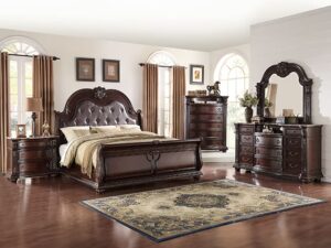 Dark wood bedroom suite with sleigh bed.