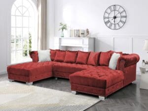 Red velvet sectional sofa with ottoman.