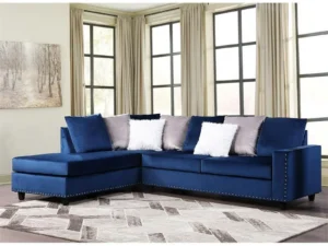 Here's an alt tag for the image: Blue velvet sectional sofa with pillows.
