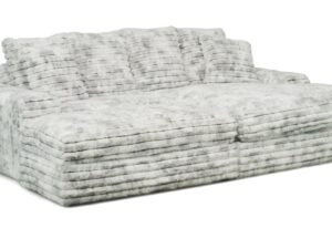 Grey plush sectional sofa with pillows.