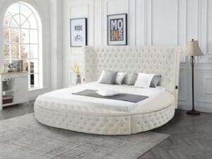 Cream round tufted velvet bed.