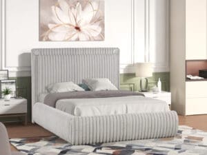 Grey upholstered bed with tufted headboard.